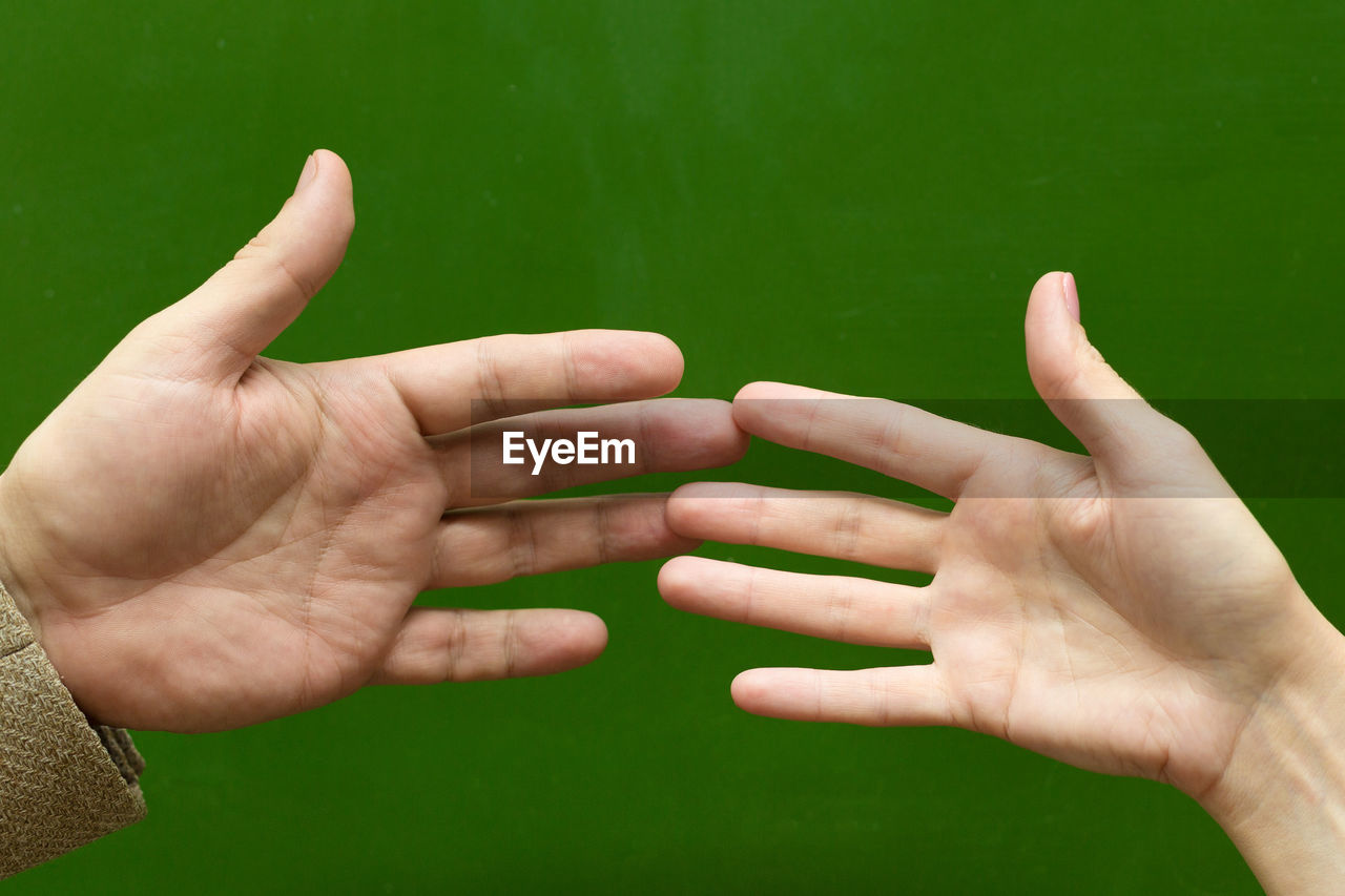 Cropped image of people hand against blurred background
