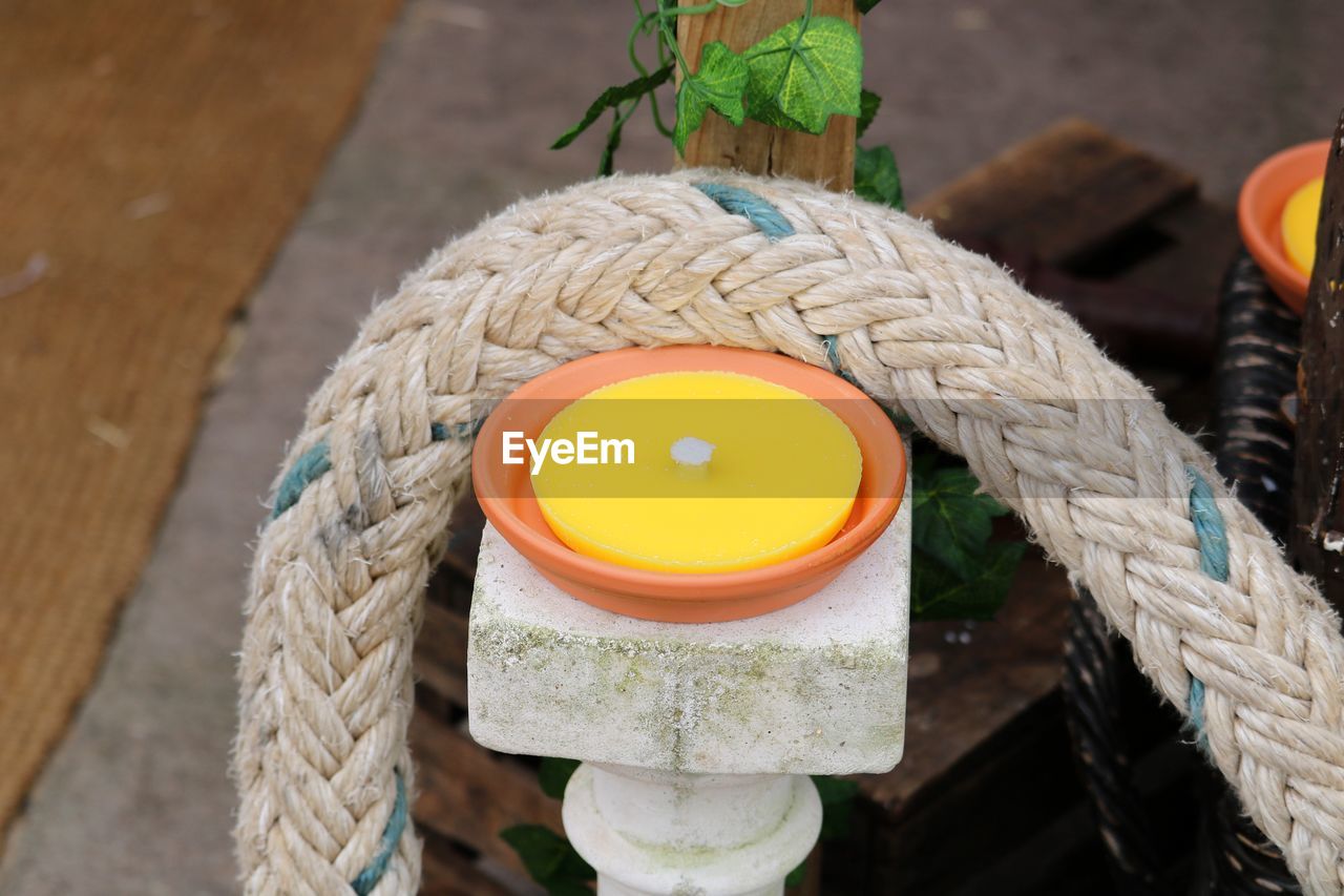 HIGH ANGLE VIEW OF ROPE ON WOODEN POST