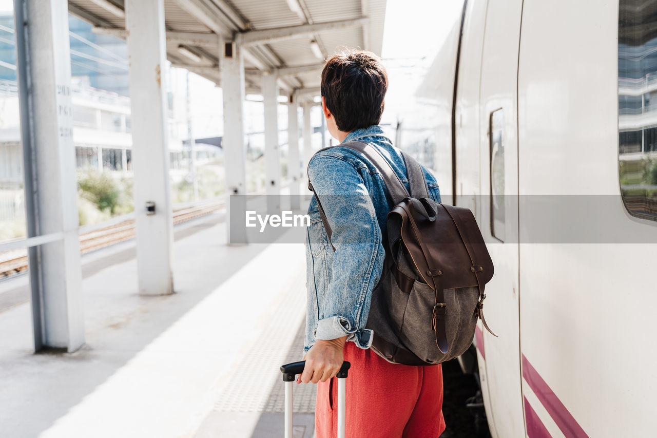 Rear view of woman standing outdoors