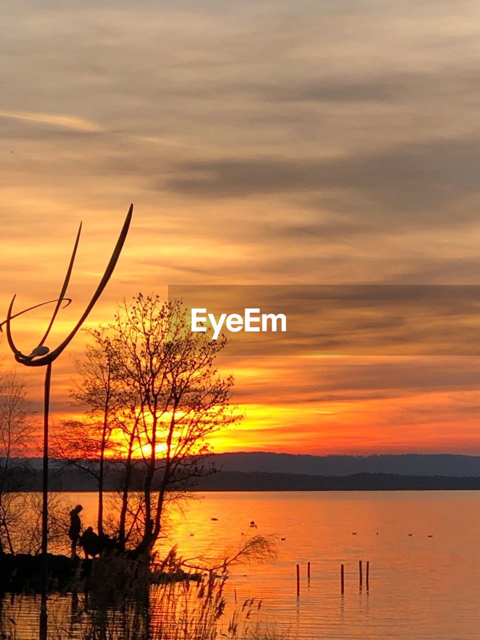 Scenic view of sea against orange sky