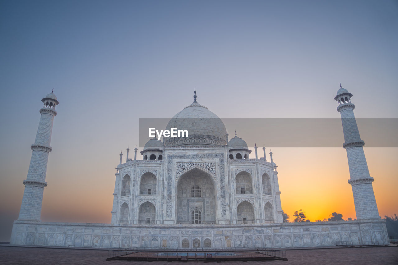 Taj mahal landscape in the fog at sunrise. eighth wonder of the world taj mahal from agra 