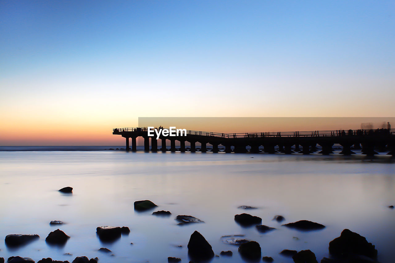 View of bridge at calm sea