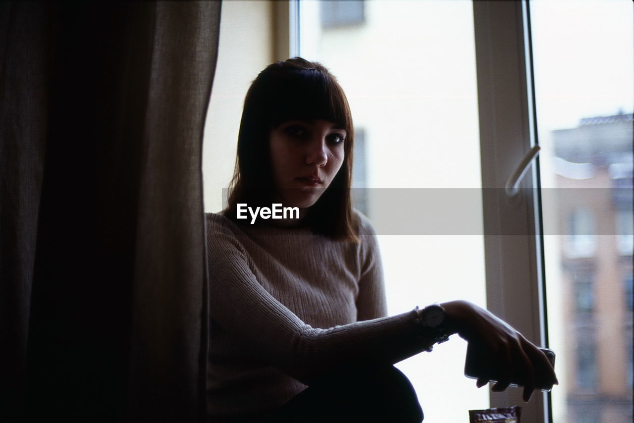 Portrait of woman by window