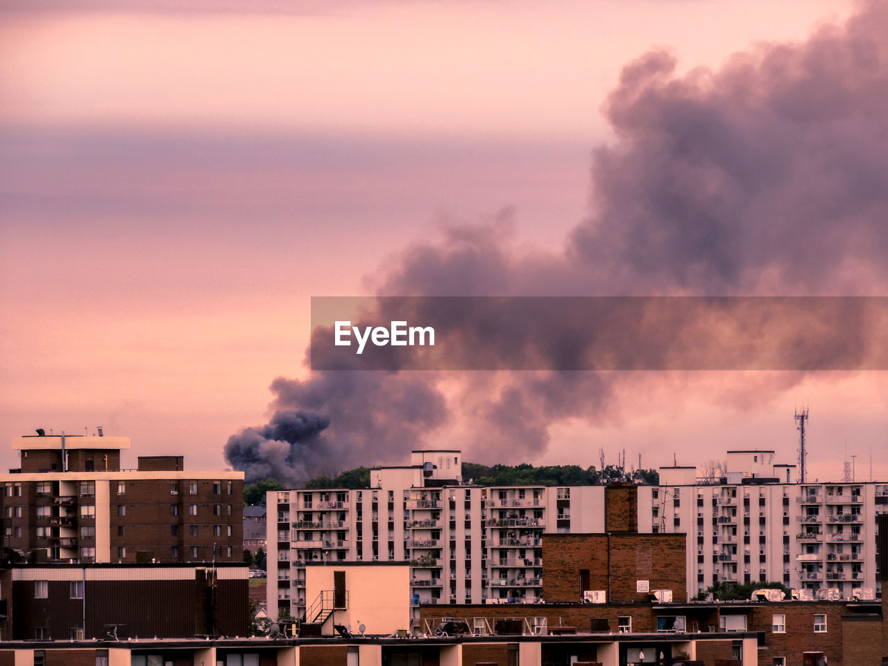 Buildings against cloudy sky