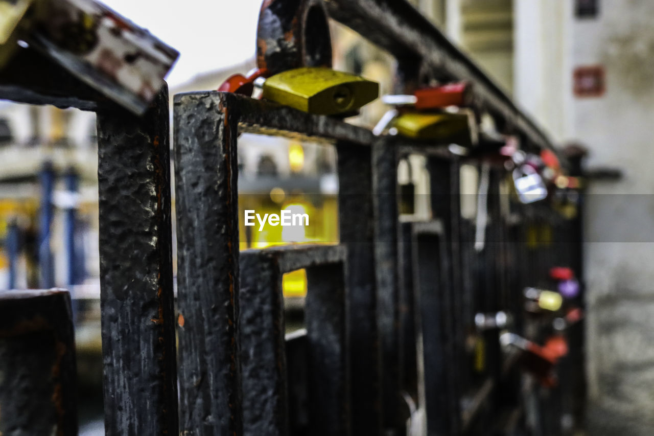 CLOSE-UP OF PADLOCK ON METALLIC STRUCTURE