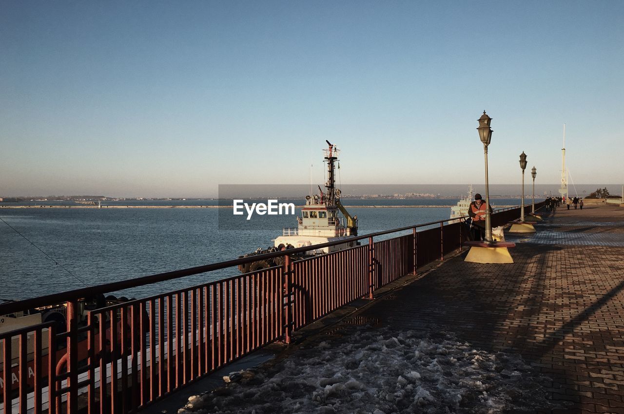 Pier on sea against clear sky