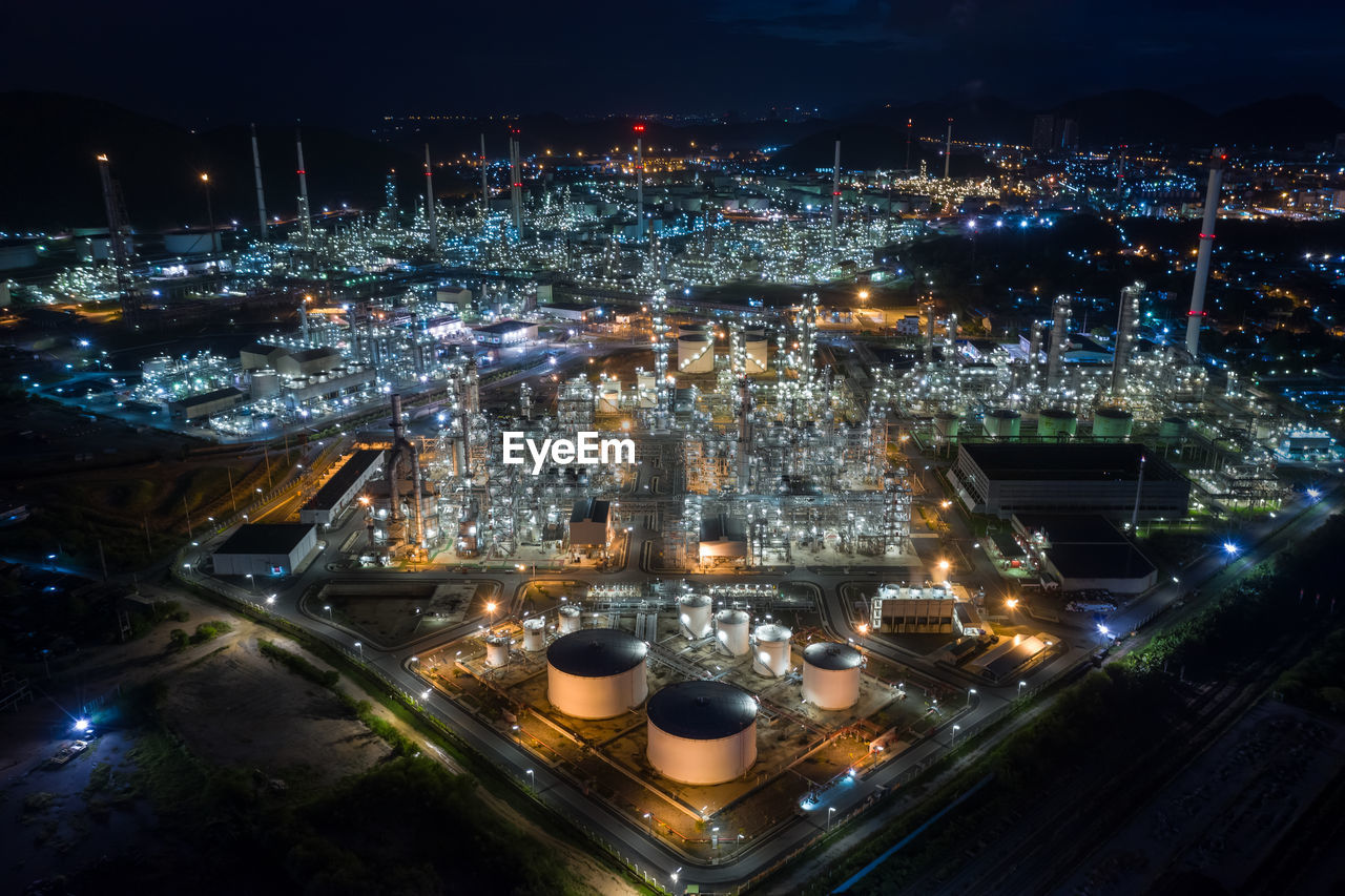 High angle view refinery of illuminated city at night