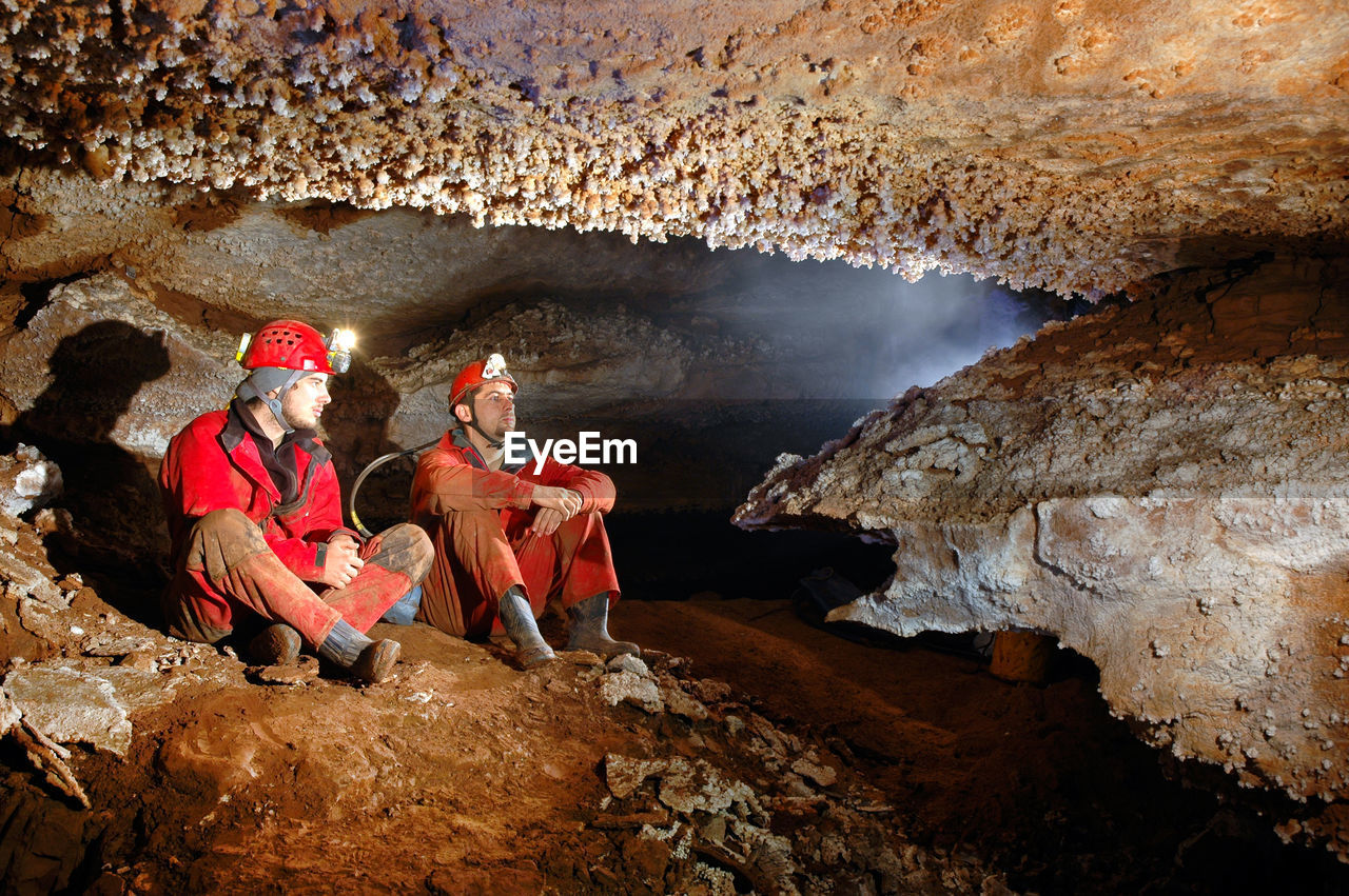 Workers sitting in cave