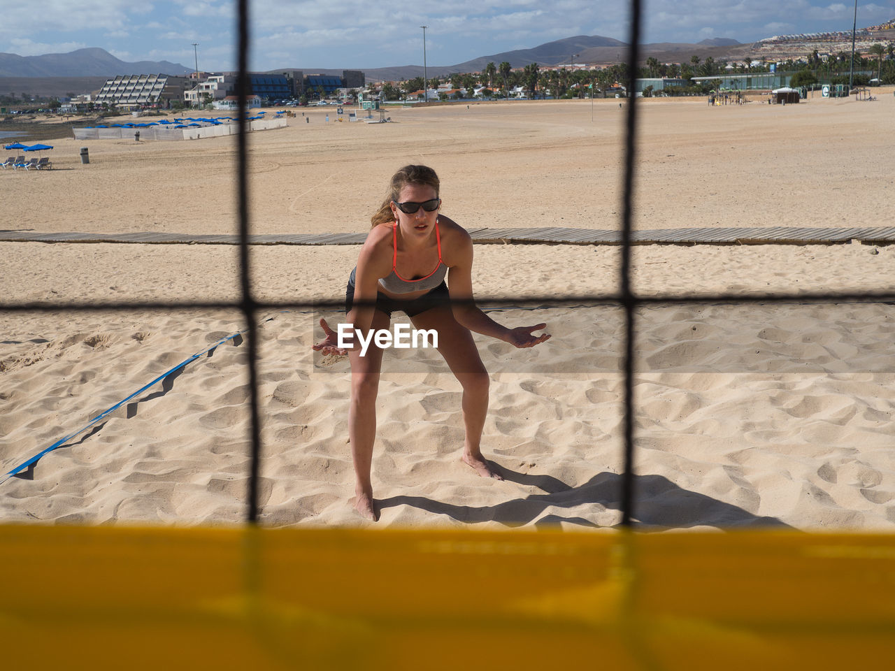 Woman playing volleyball at beach