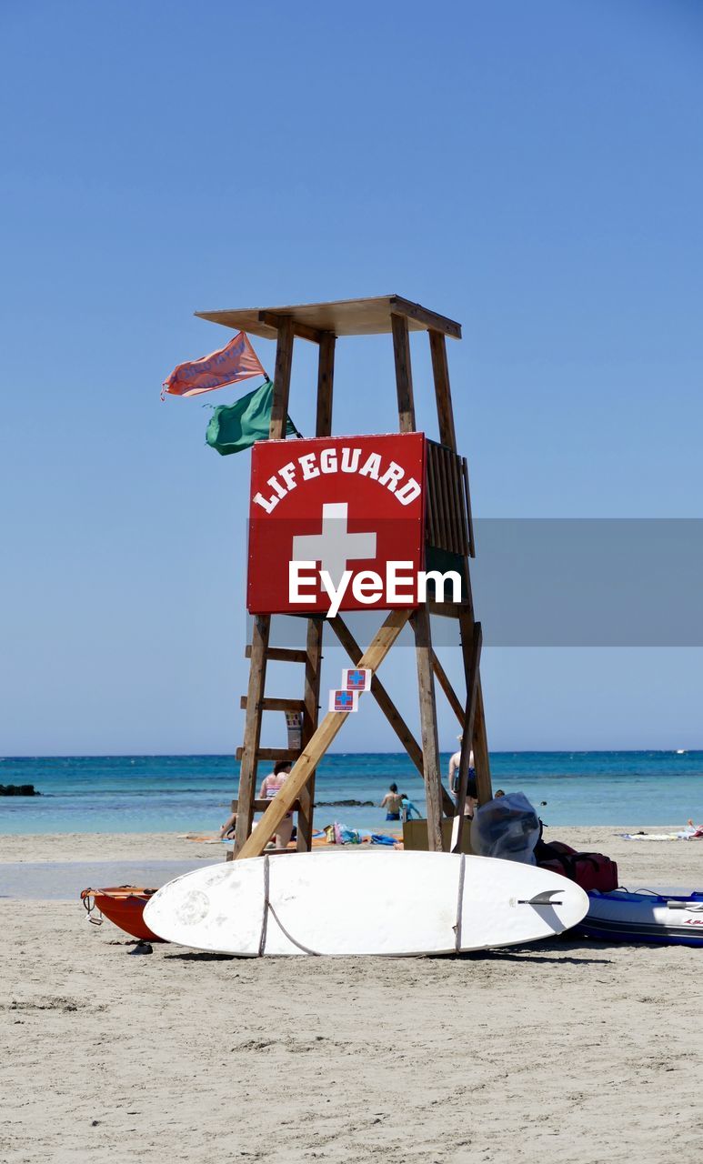 Lifeguard hut on beach against clear sky