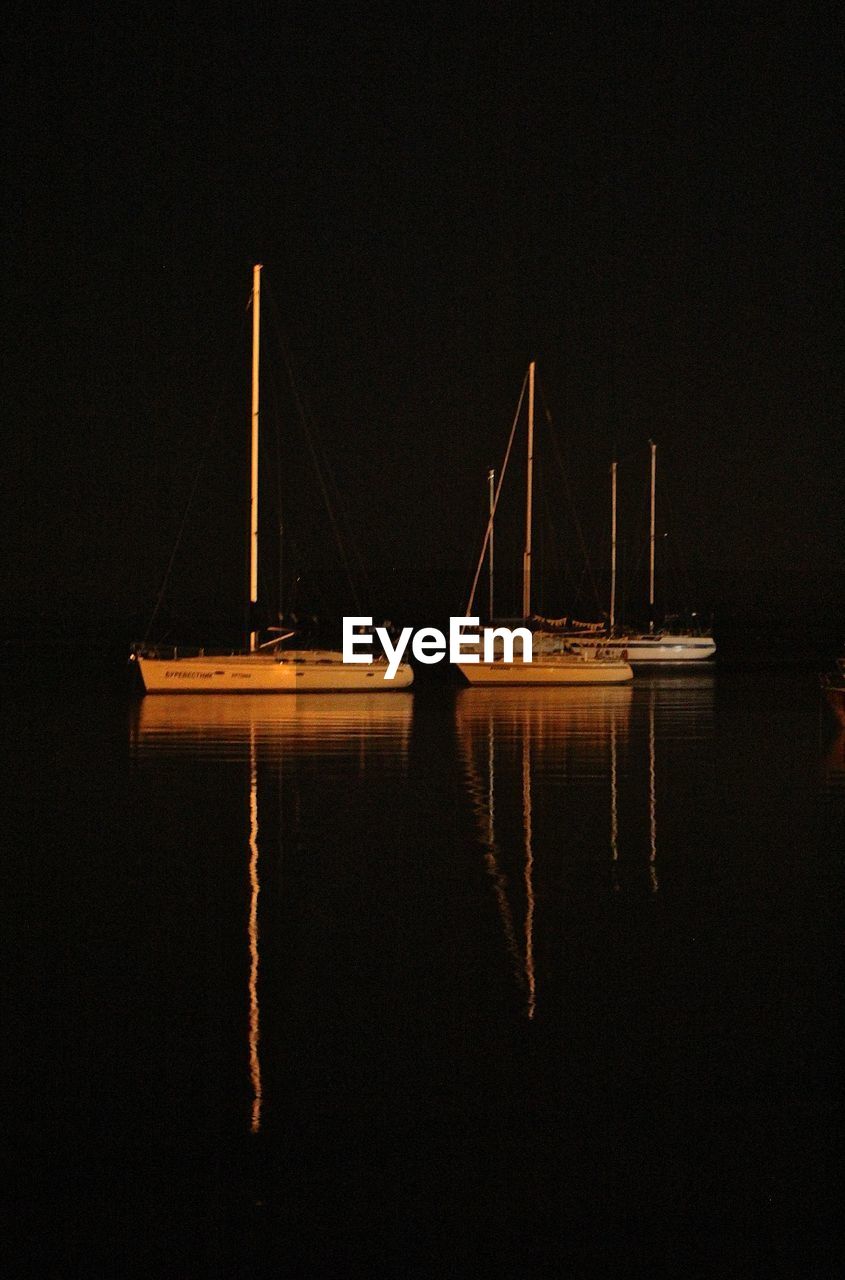 Sailboat in sea at night