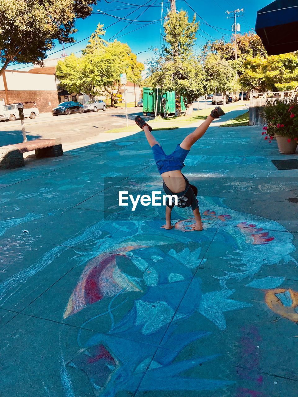 BOY JUMPING IN SWIMMING POOL