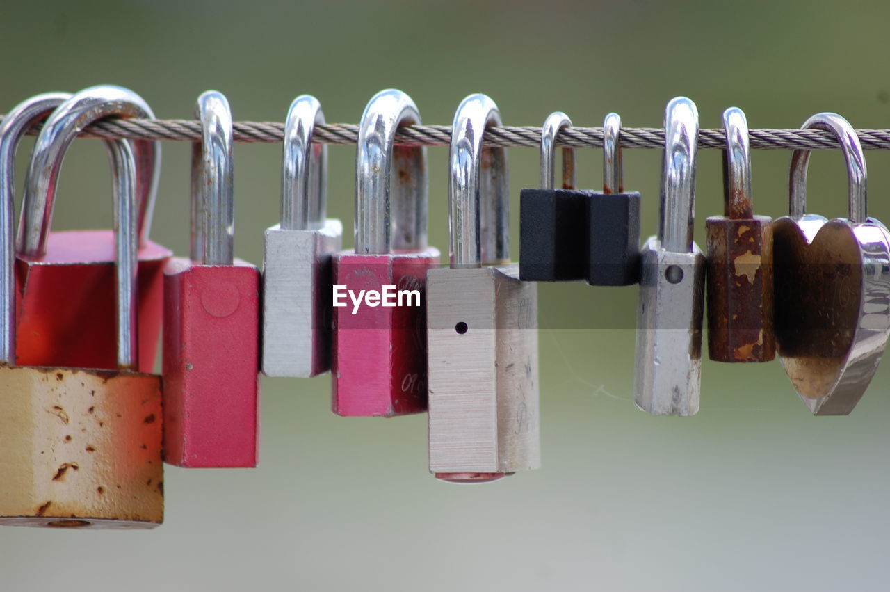 Close-up of padlocks hanging on metal