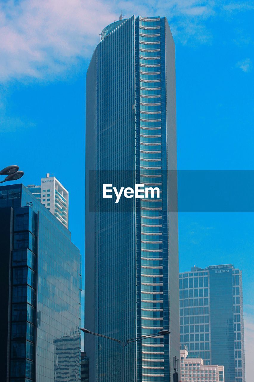 LOW ANGLE VIEW OF BUILDINGS AGAINST BLUE SKY