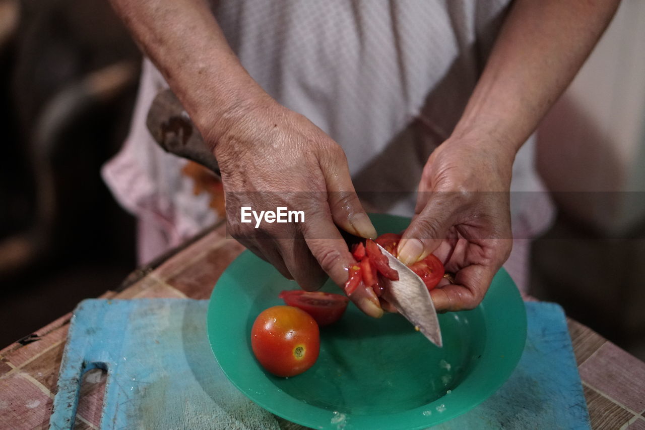 Midsection of man preparing food