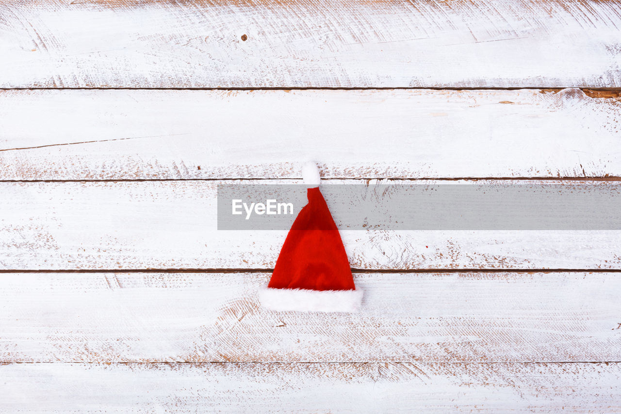 High angle view of santa hat on wooden table