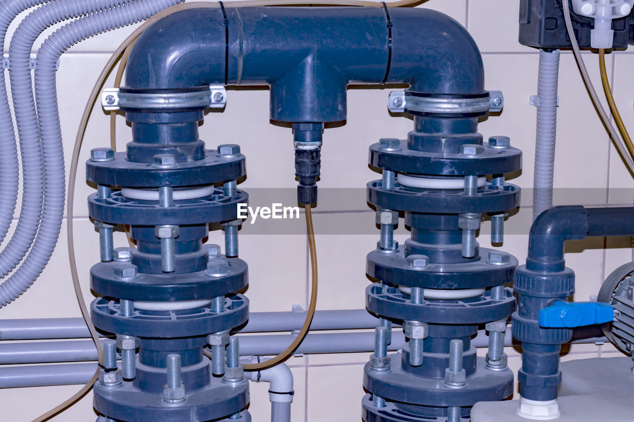 Close-up of pipes in water at carwash