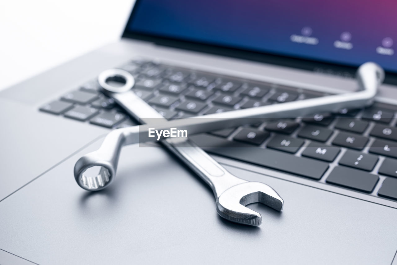 Computer fixing, service or maintenance concept background. working tools on modern laptop computer