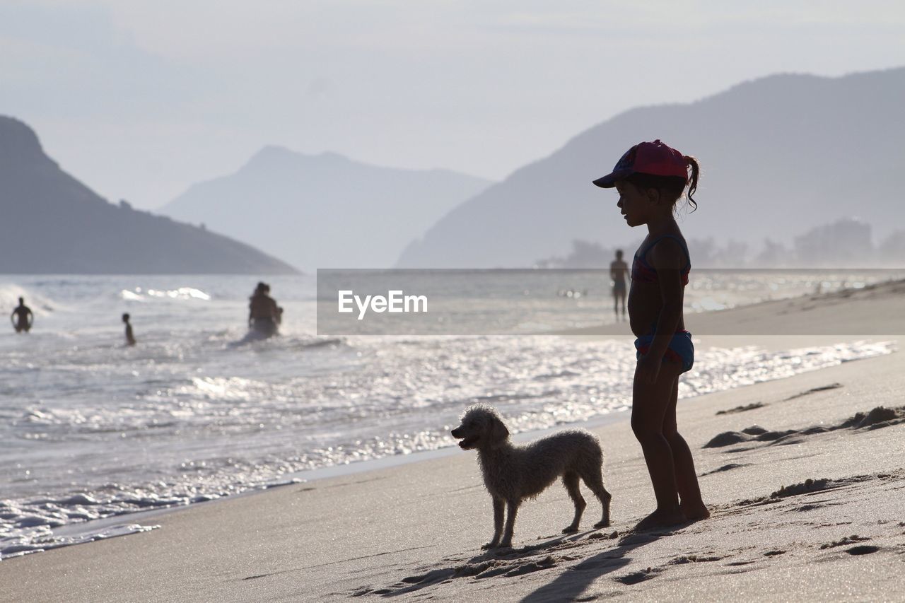 Girl with dog on beach