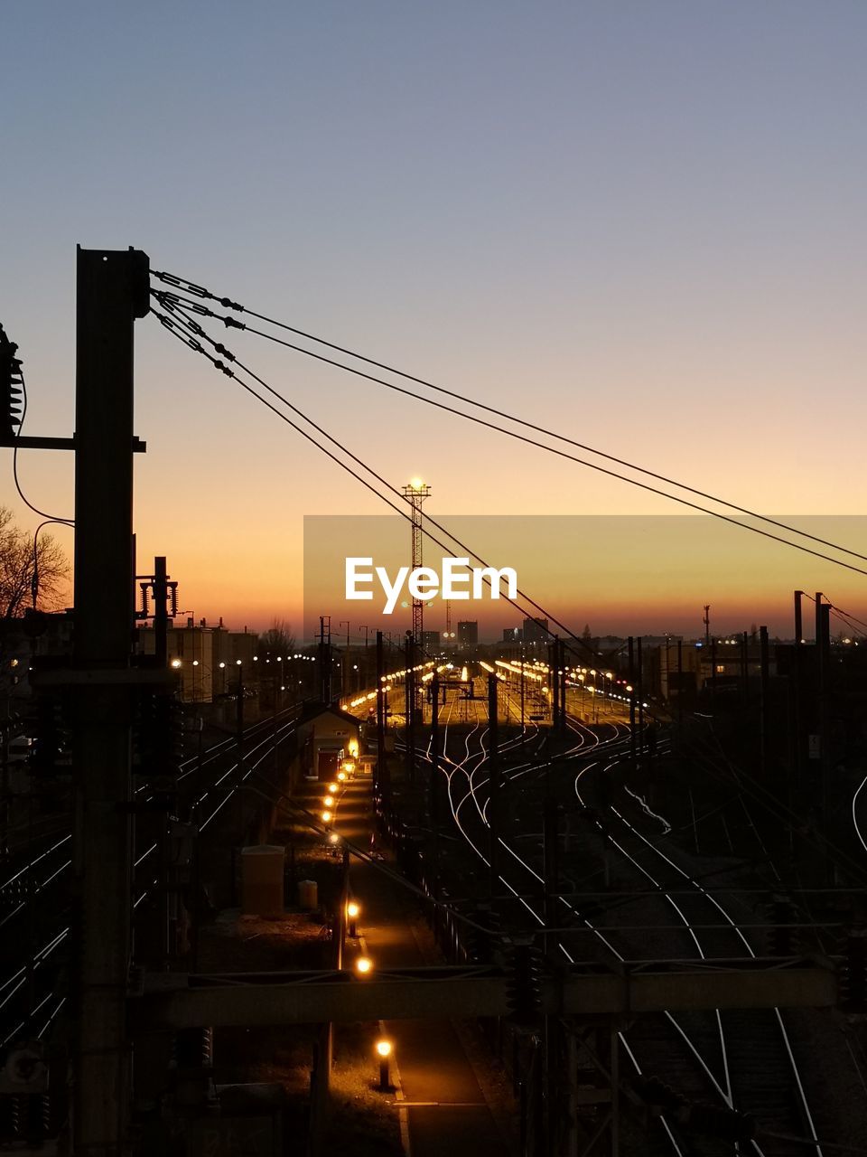 Railroad tracks against sky during sunset