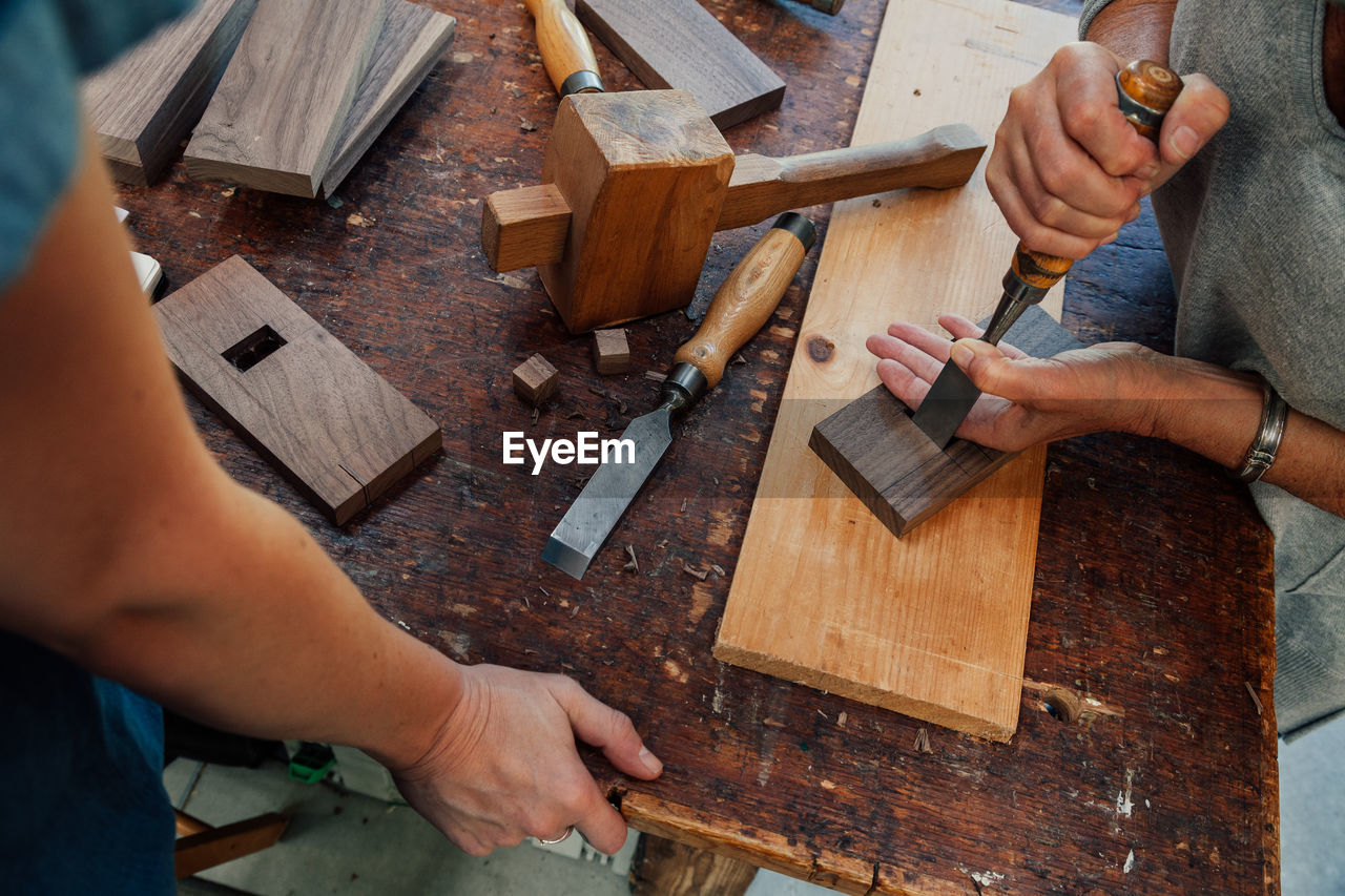 Close-up of carpenters preparing furniture