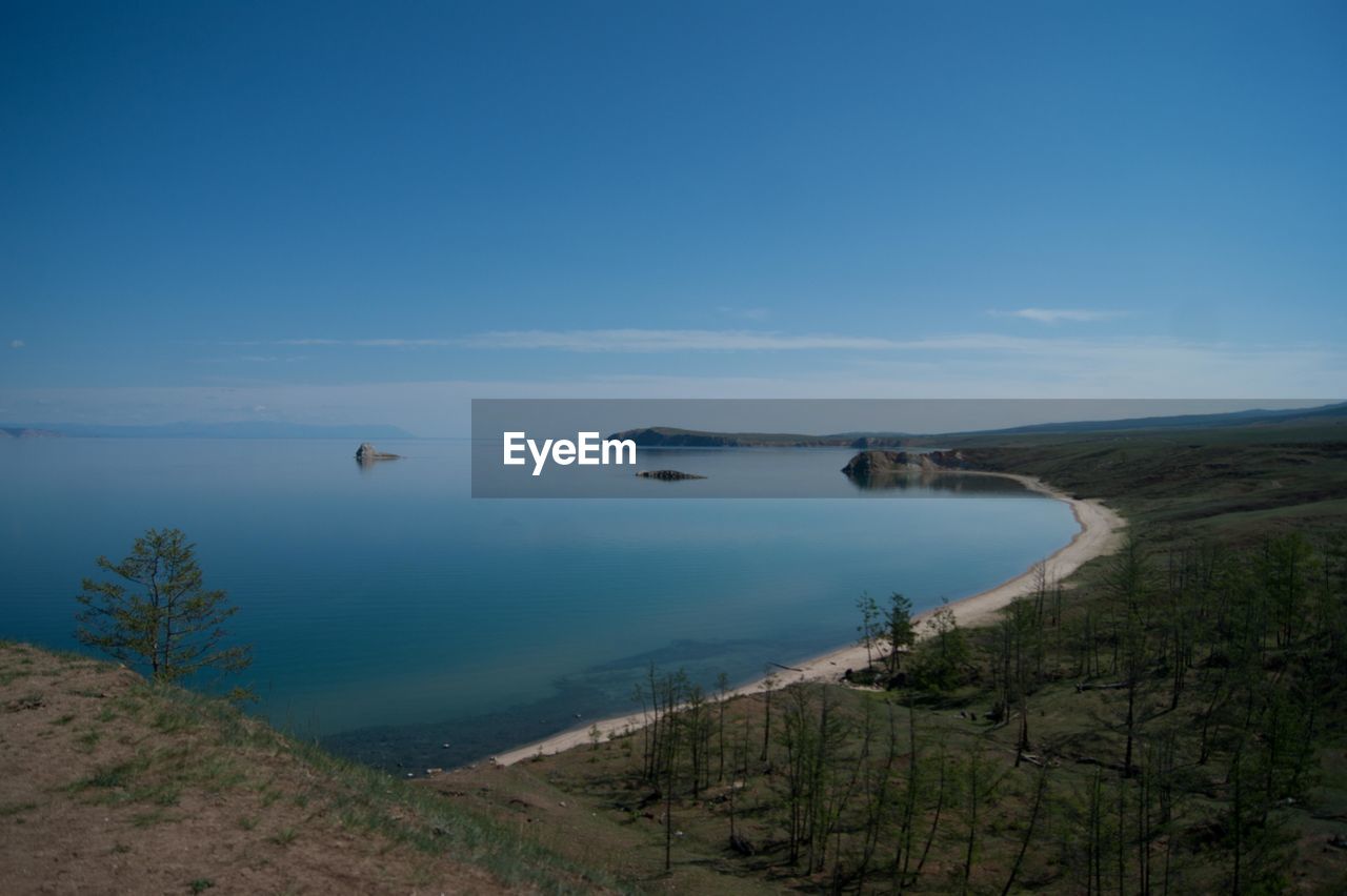 Scenic view of landscape against blue sky