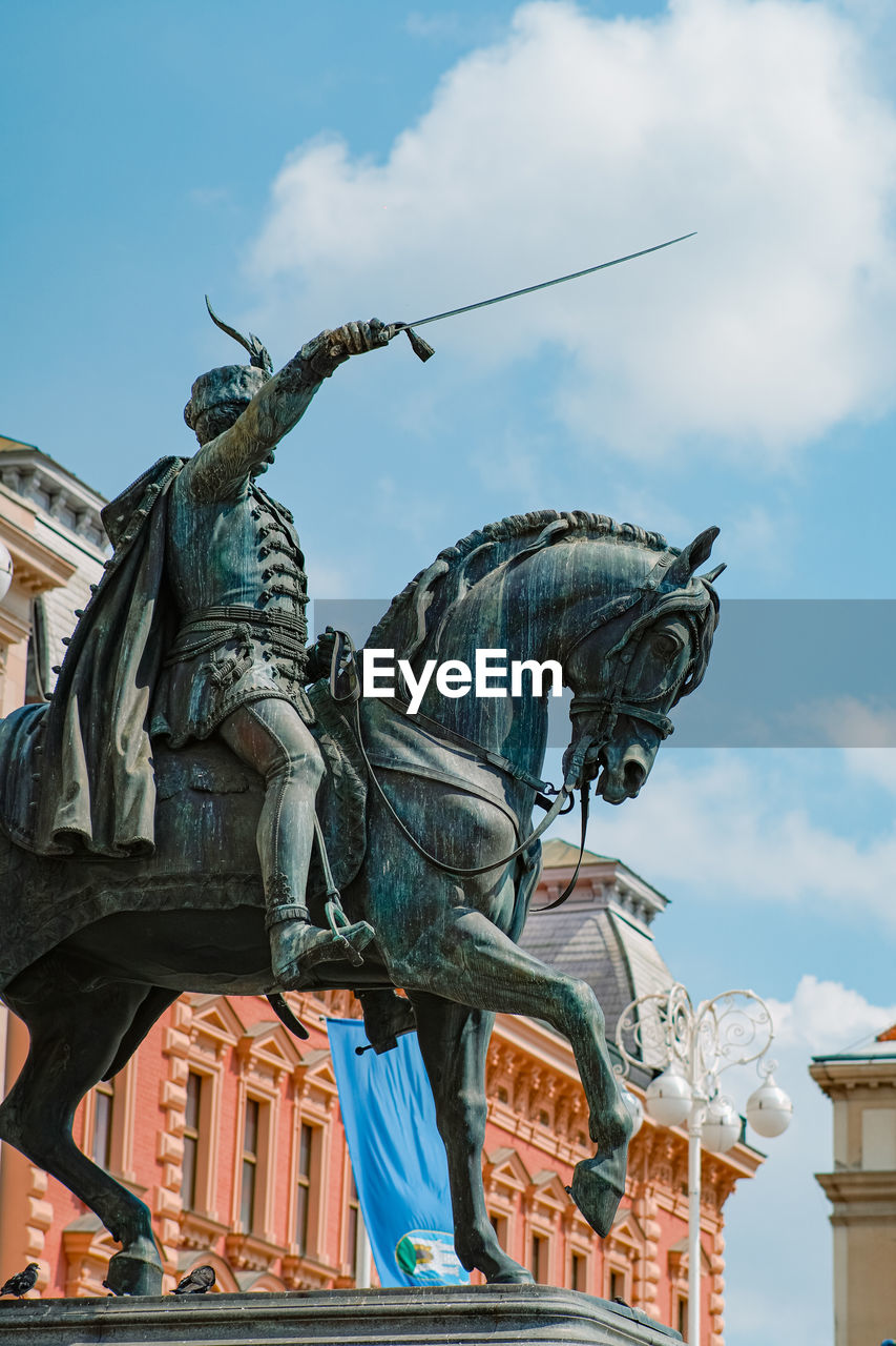 Low angle view of statue against sky
