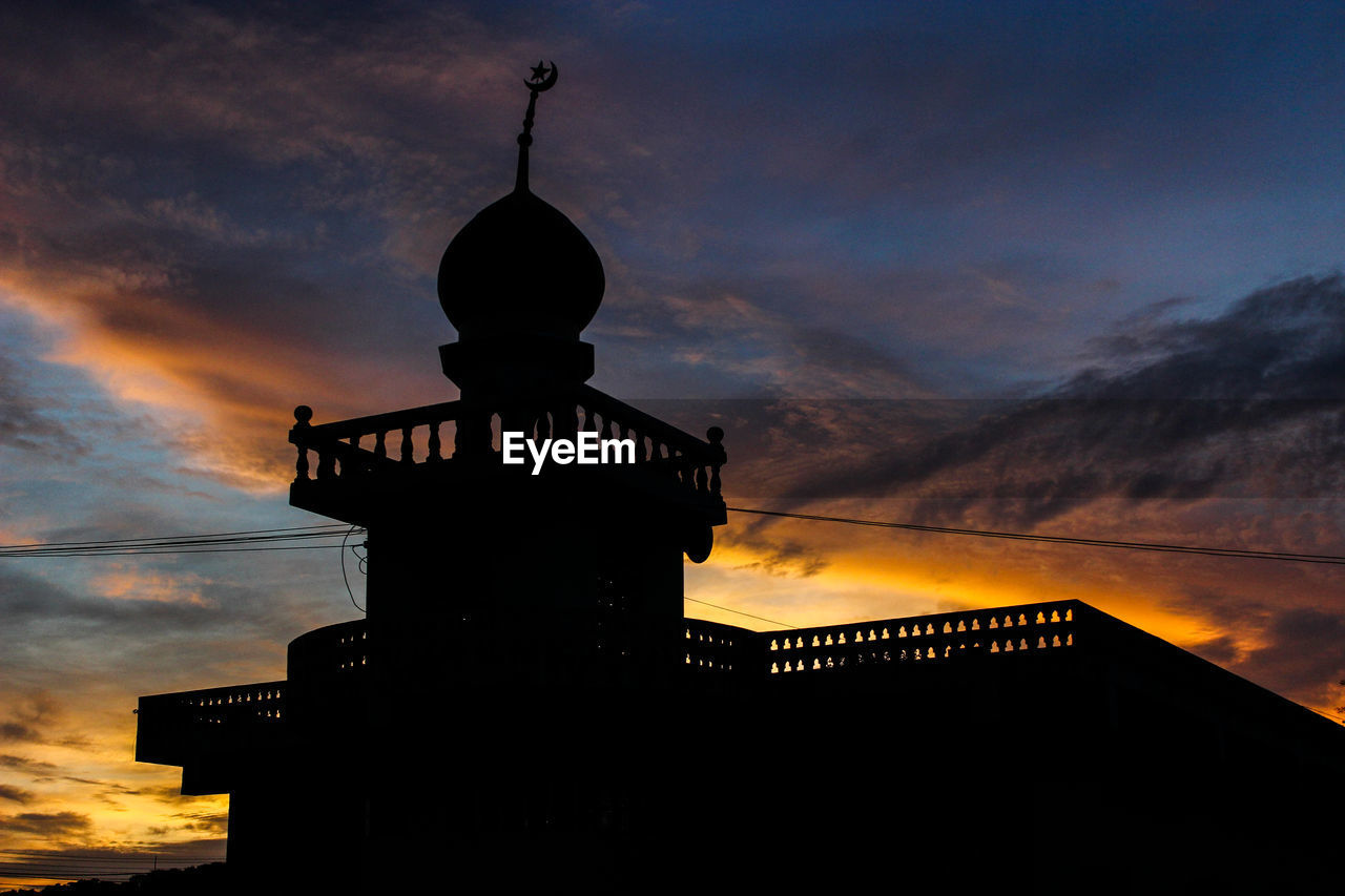 Low angle view of silhouette mosque against sky during sunset