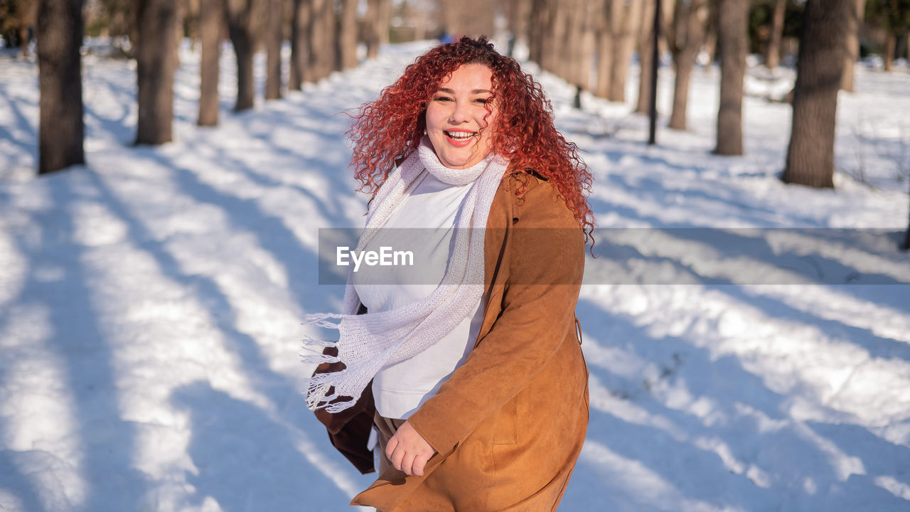 young woman standing on snow