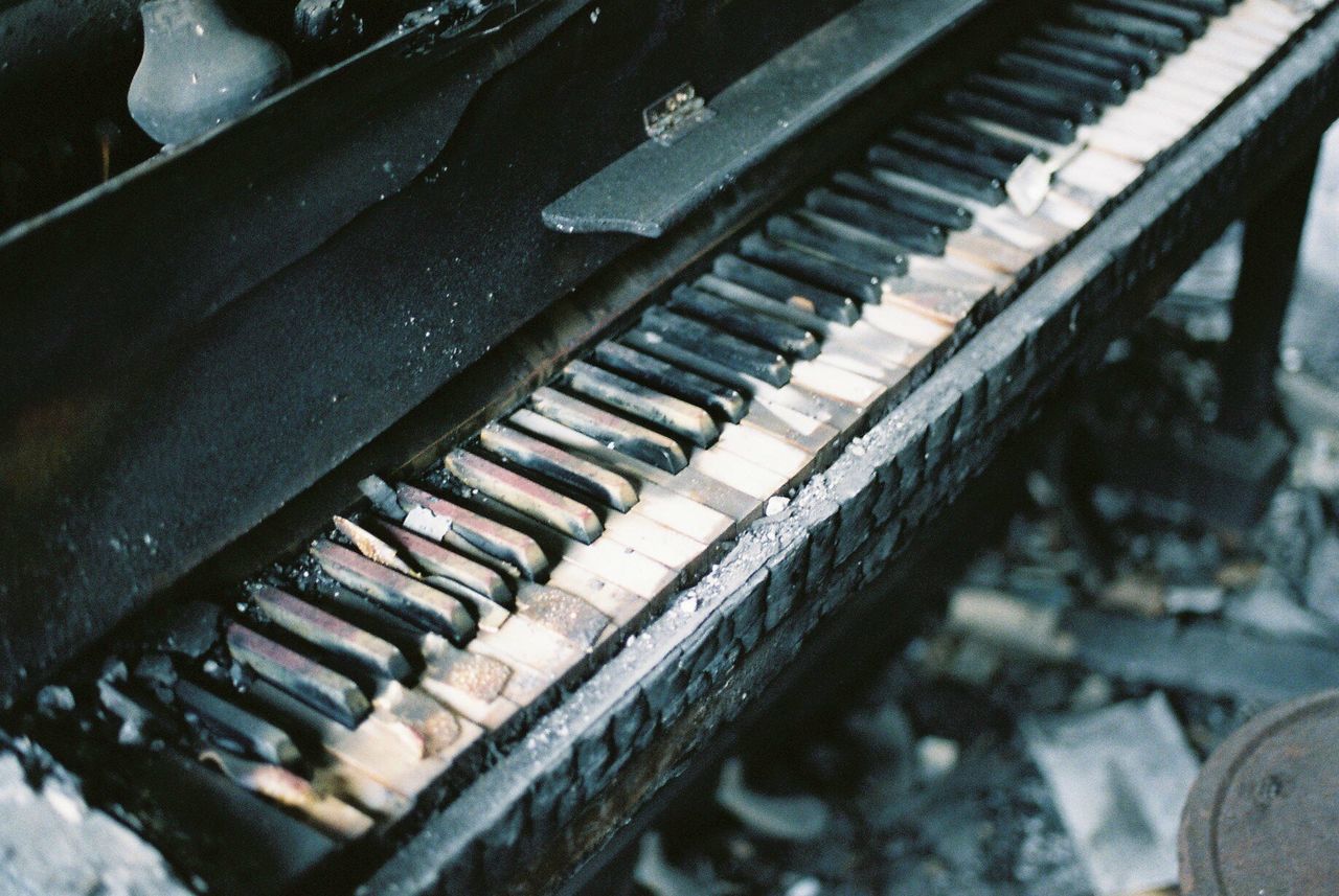 CLOSE-UP OF DAMAGED PIANO