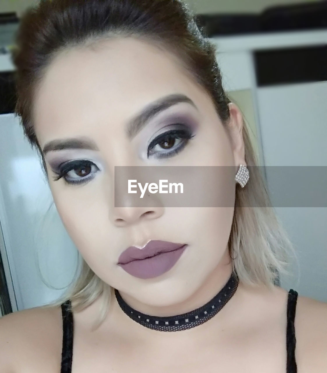 Close-up portrait of young woman wearing make-up