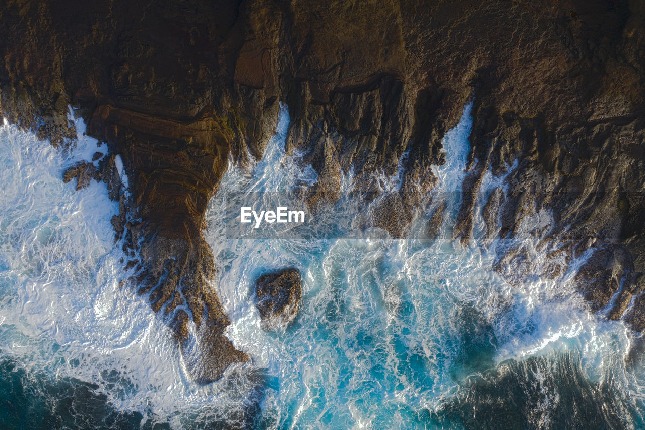 Aerial view of rock formations in sea