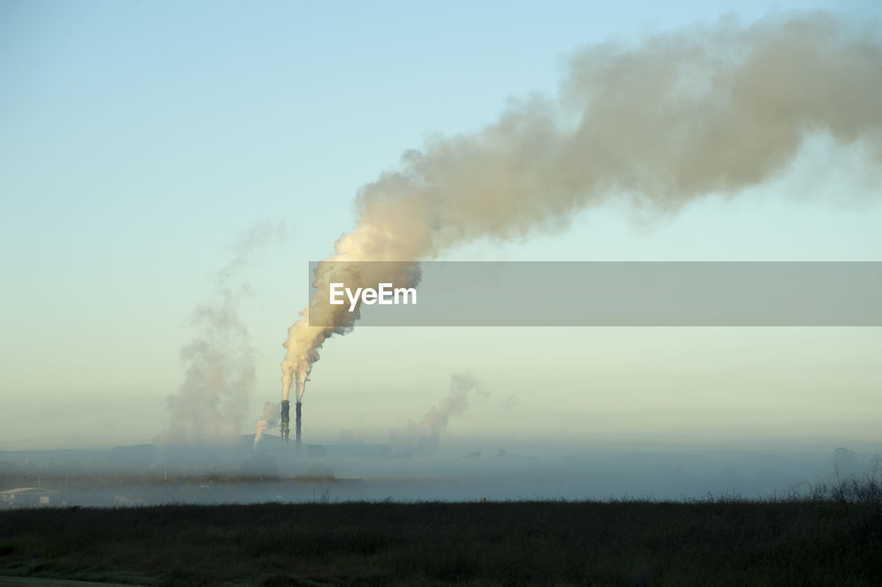 SMOKE EMITTING FROM CHIMNEY AGAINST SKY