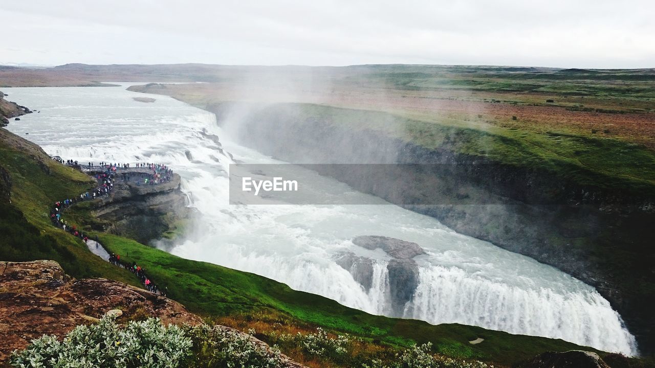 Scenic view of waterfall against sky