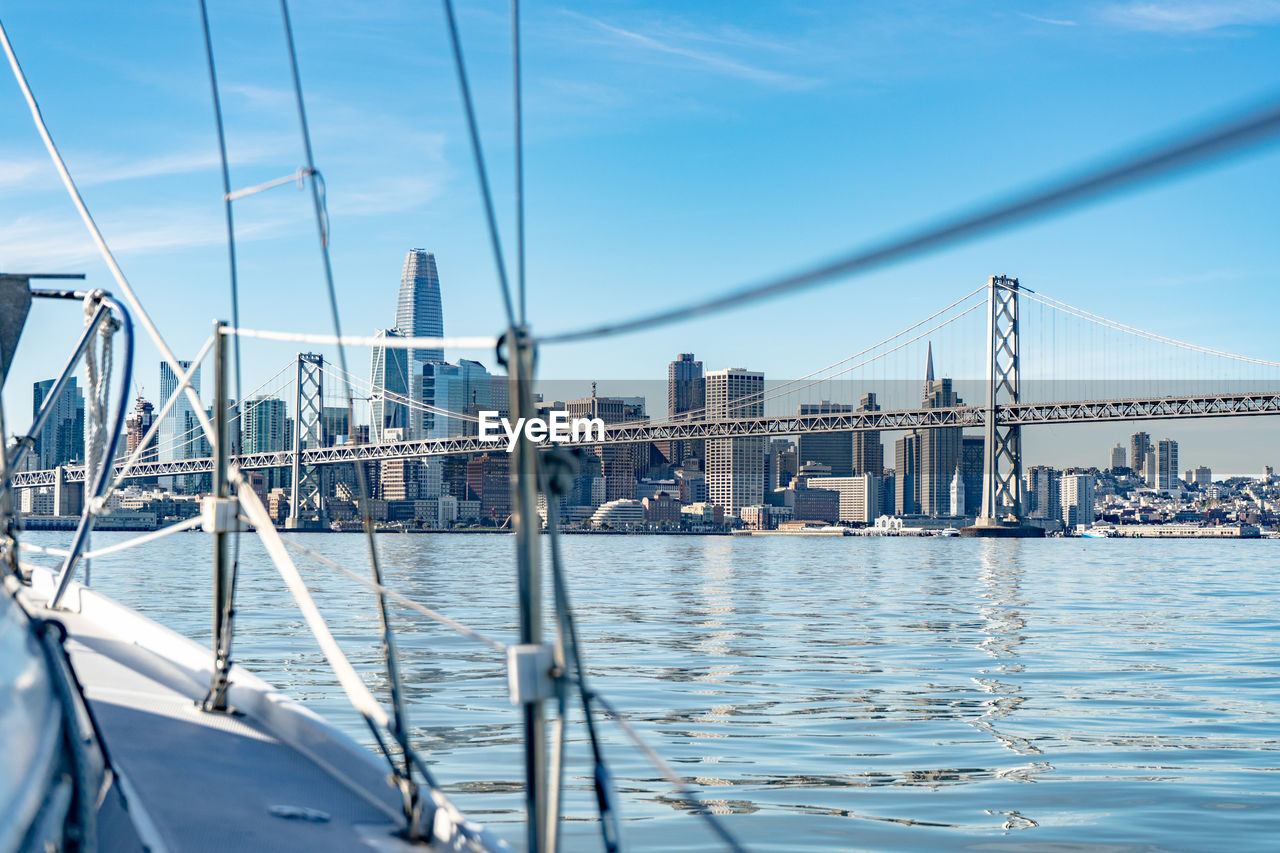 Sailboats in city against sky