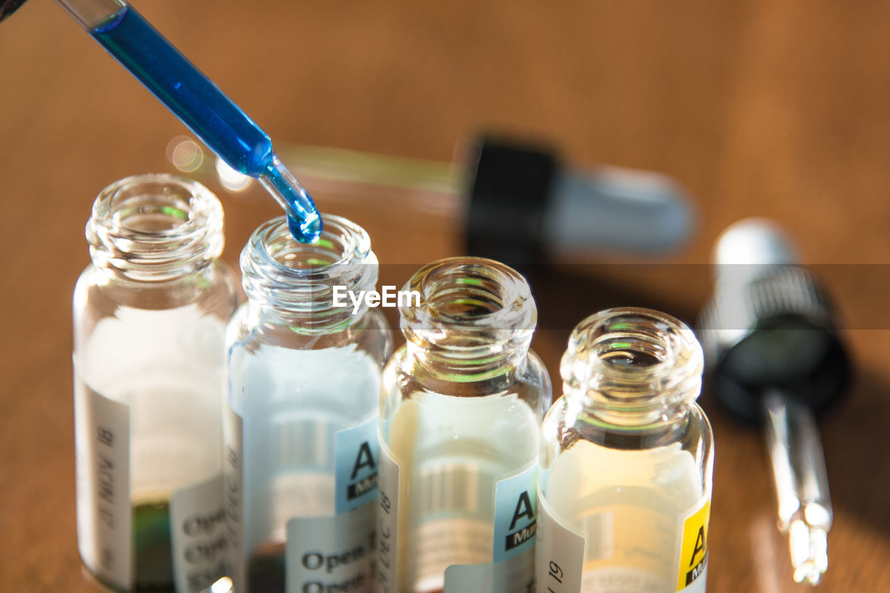 Close-up of medical sample dripping in bottle on table