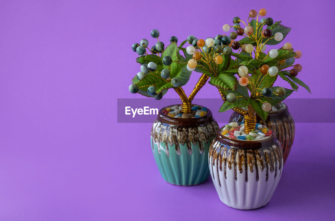 purple, plant, flower, studio shot, indoors, colored background, no people, nature, flowering plant, food, food and drink, freshness, vase, decoration, still life, violet, growth, floral design, flowerpot, beauty in nature, floristry, blue, table, cupcake