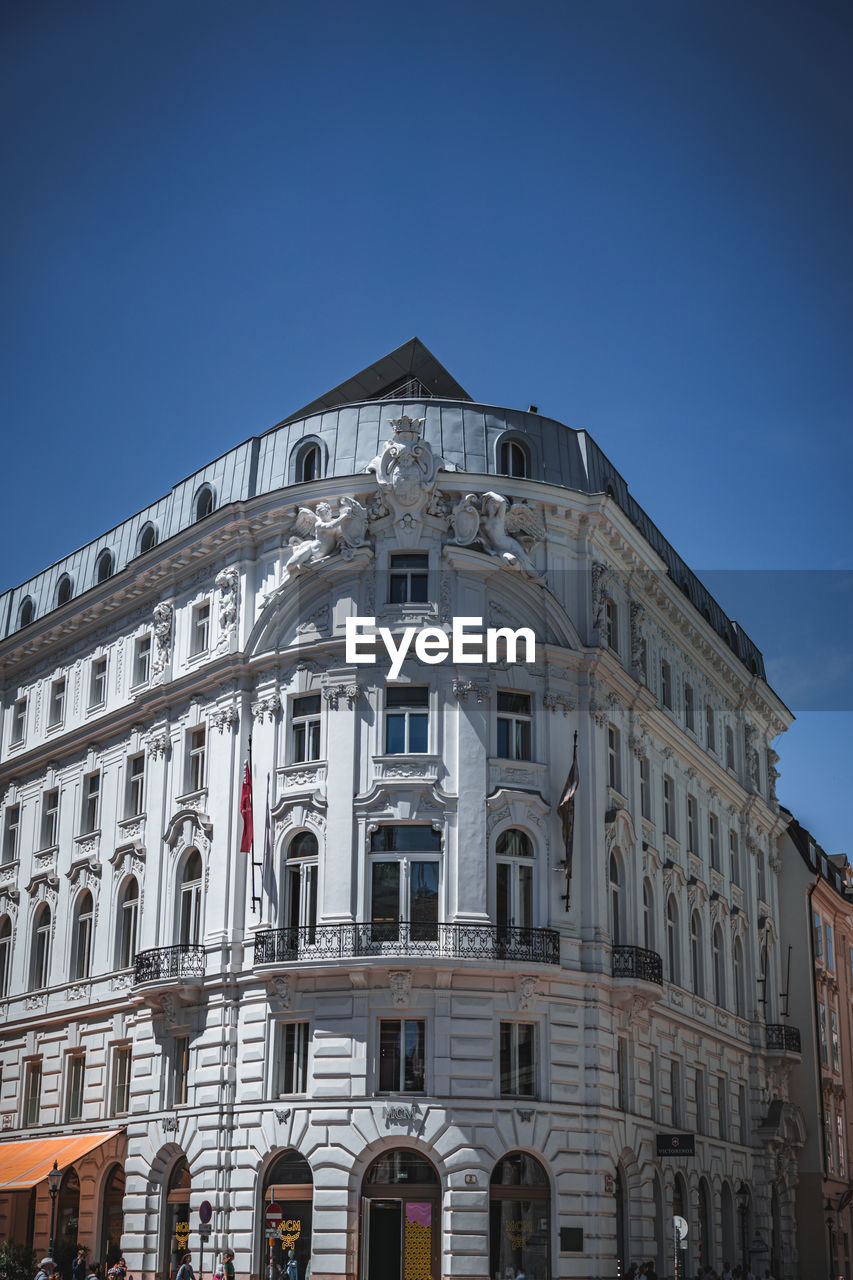 Low angle view of building against clear blue sky