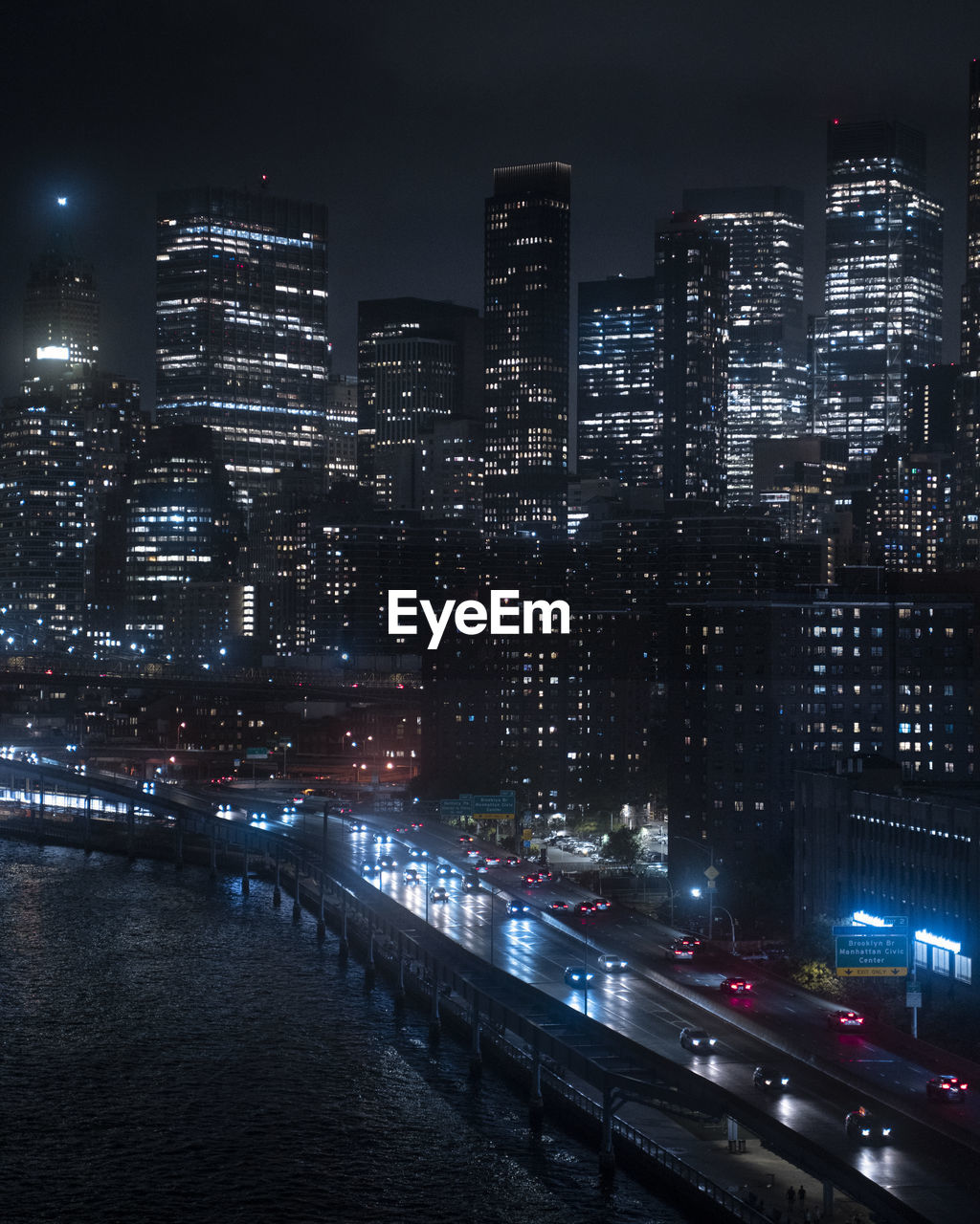 High angle of the highway in new york city at night with the manhattan skyline in the background