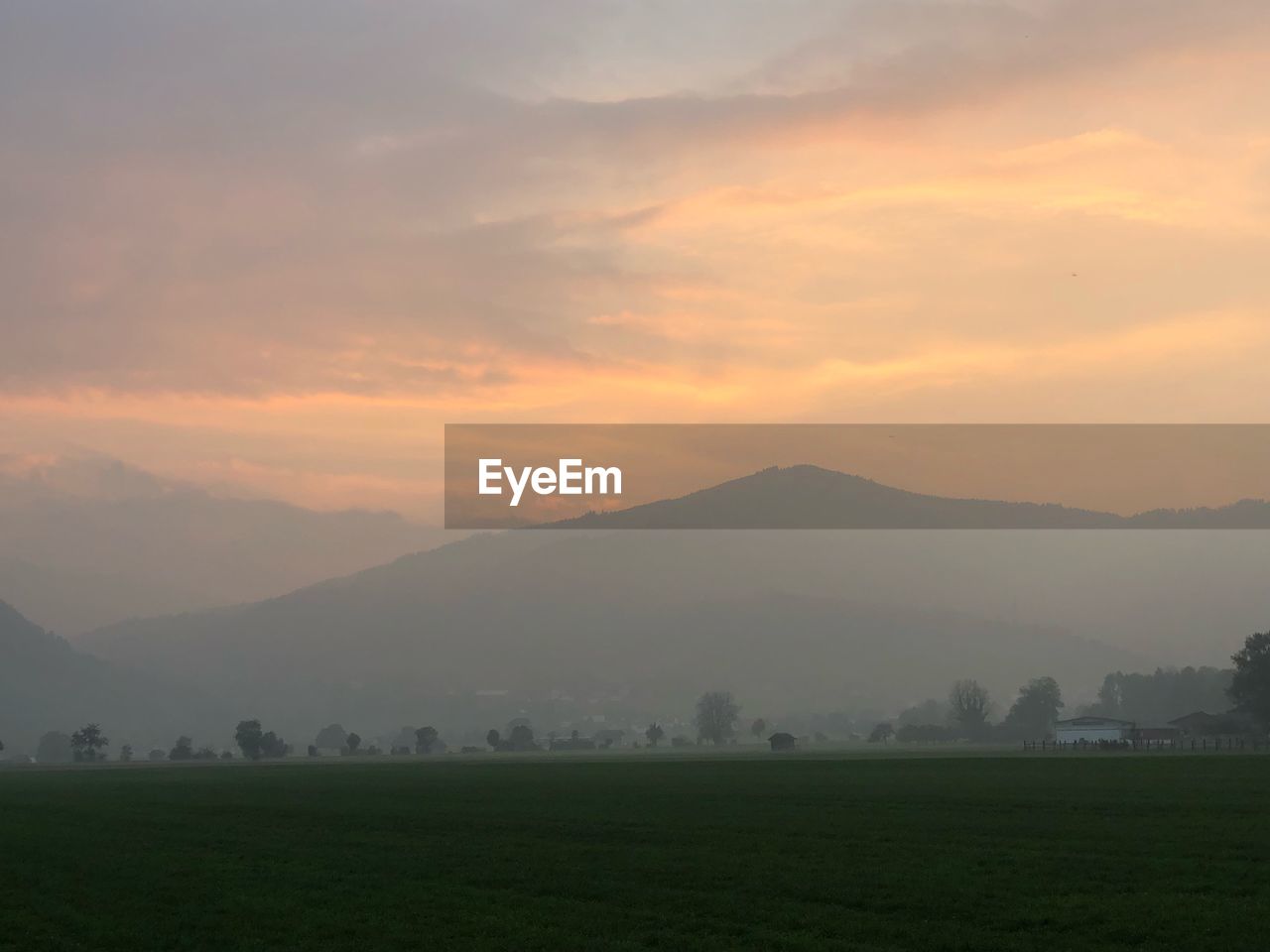 Scenic view of field against sky during sunset