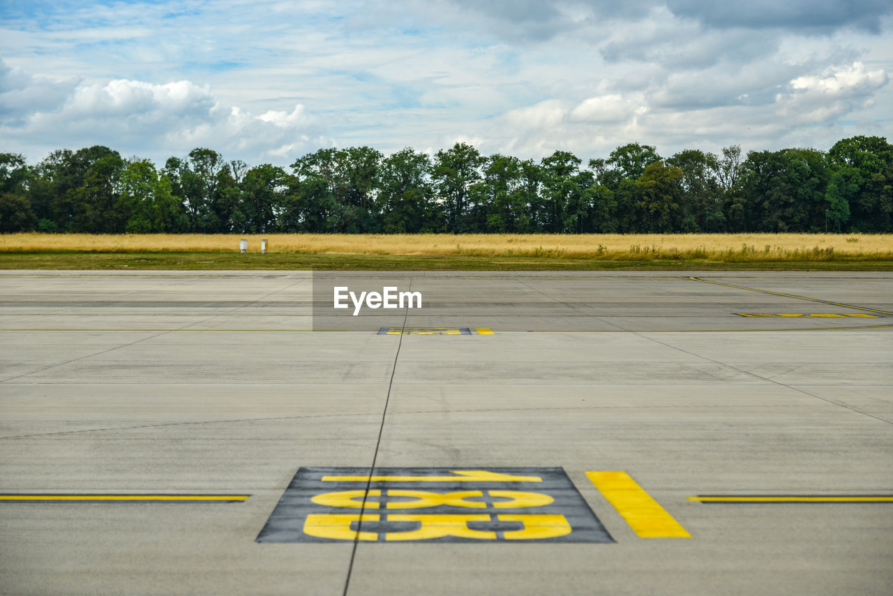View of inscription on airport runway against sky