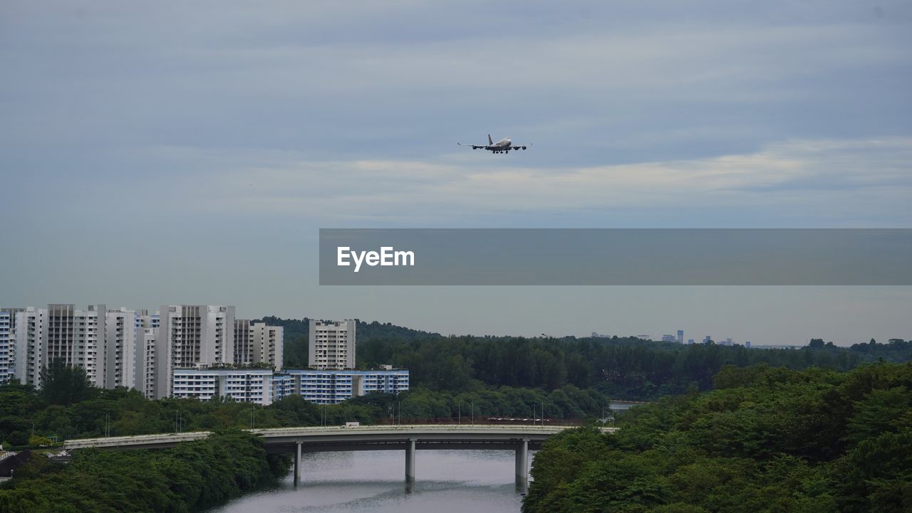 sky, transportation, flying, air vehicle, architecture, mode of transportation, built structure, building exterior, nature, airplane, tree, mid-air, cloud, city, no people, vehicle, plant, building, travel, day, outdoors, drone, motion, helicopter, water