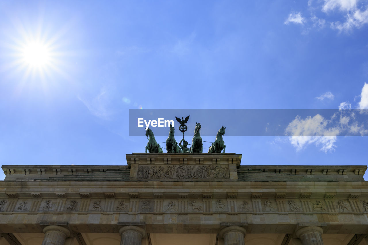 LOW ANGLE VIEW OF STATUE AGAINST CLOUDY SKY