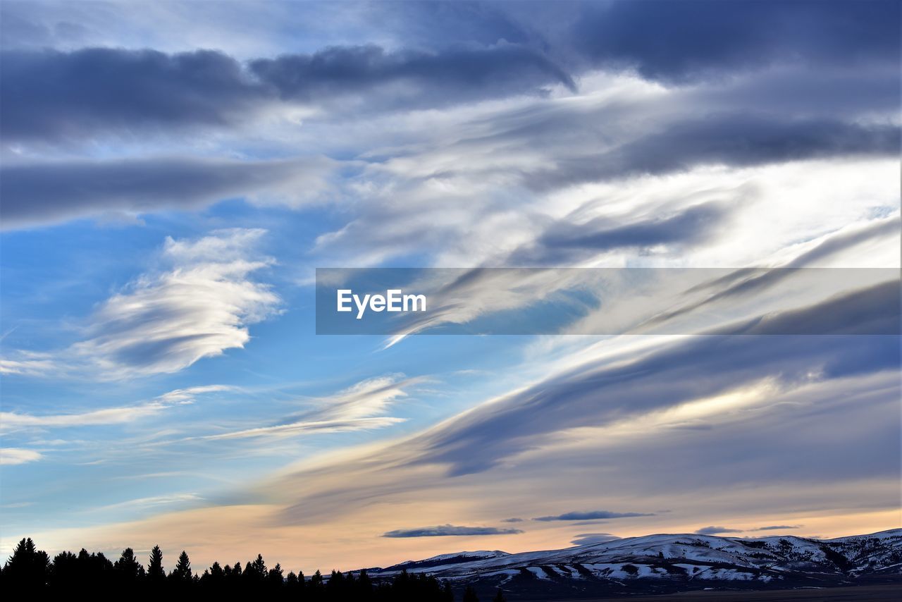 LOW ANGLE VIEW OF SNOWCAPPED MOUNTAIN AGAINST SKY DURING WINTER