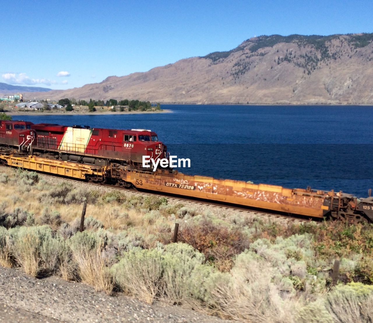 High angle view of train on track at field by lake