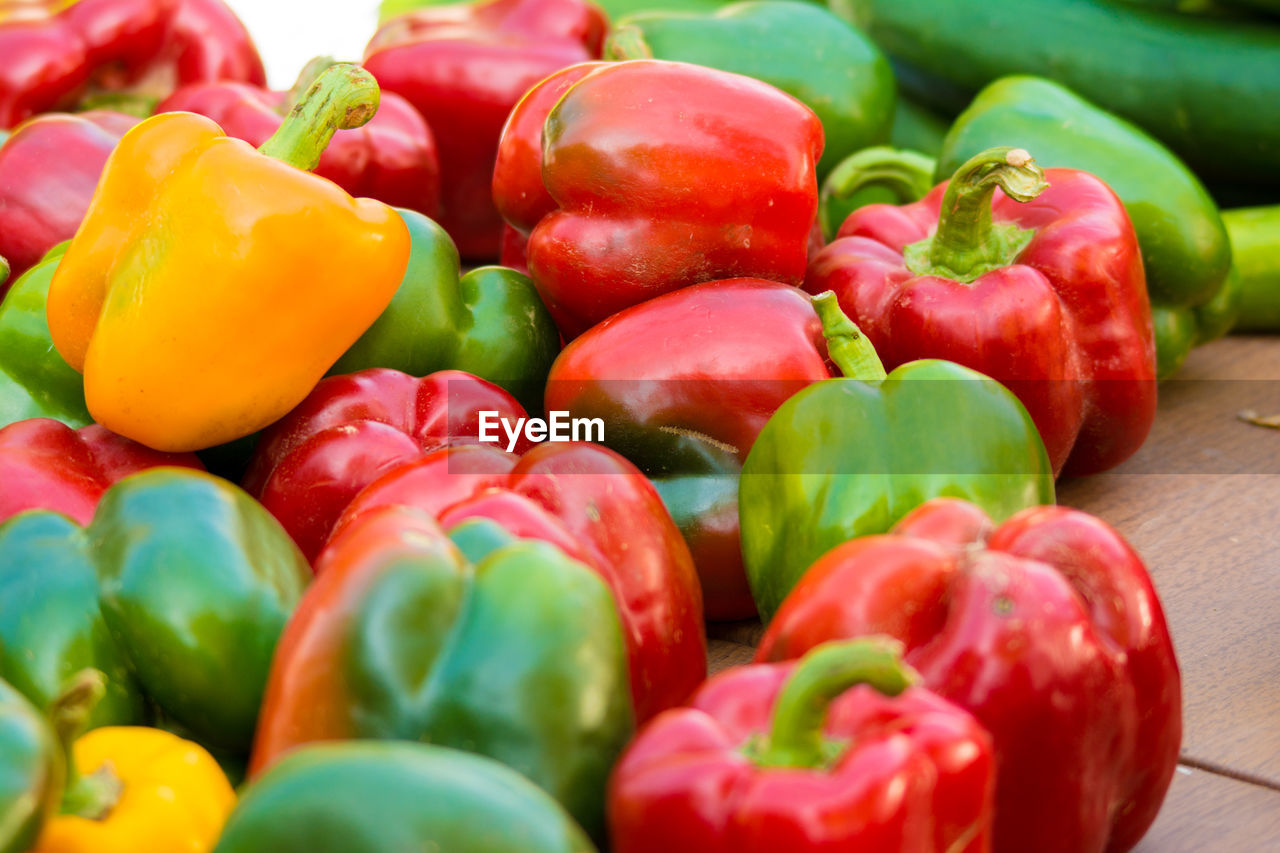 CLOSE-UP OF RED BELL PEPPERS IN CONTAINER
