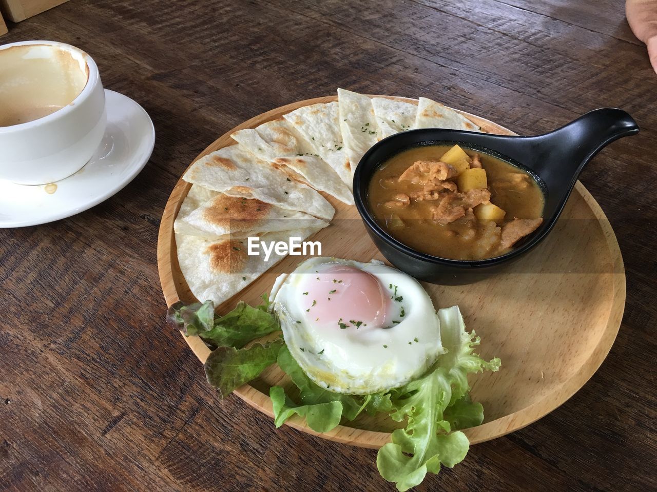 High angle view of food by empty coffee cup on table