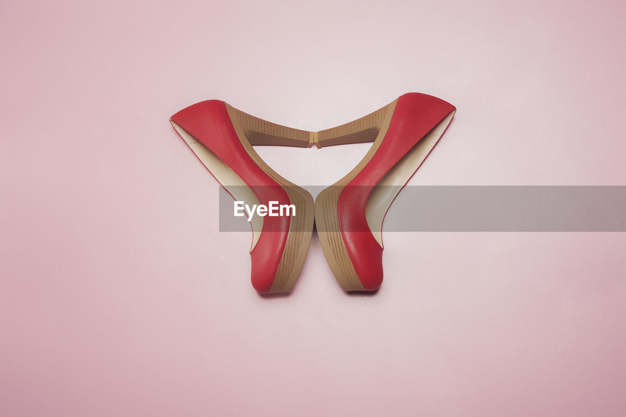 High angle view of high heels on pink background