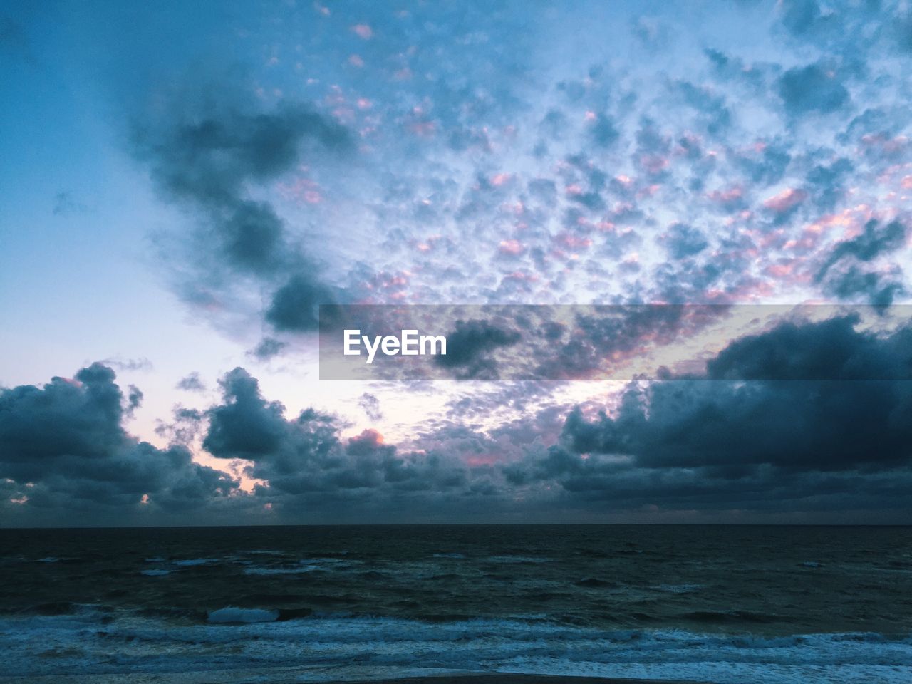 Scenic view of sea against dramatic sky