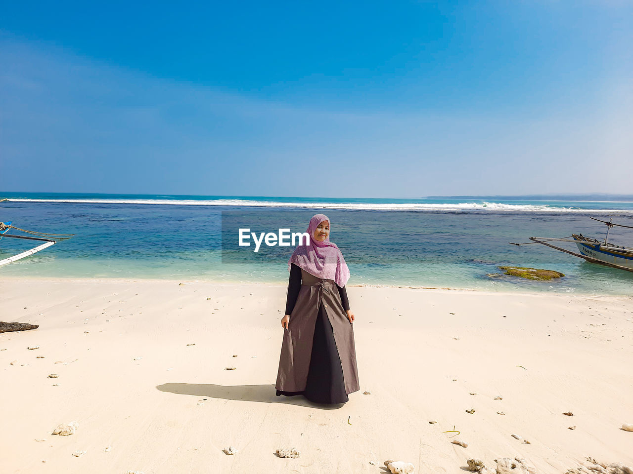 Woman on beach against sky